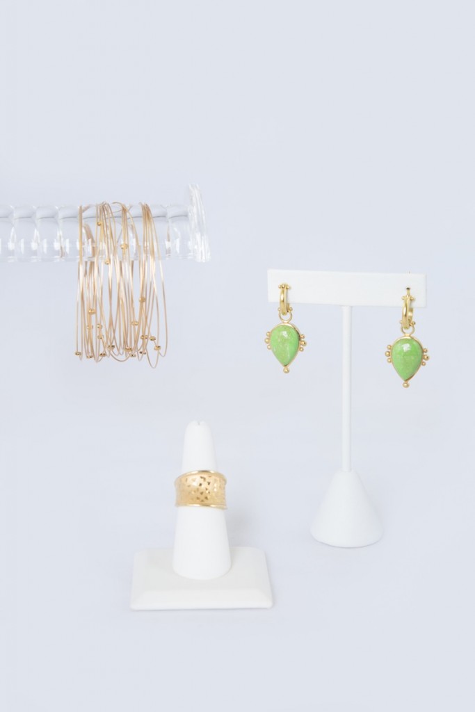 green earrings, gold bangles, gold ring