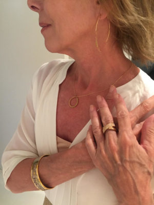 gold pendant necklace, gold and crystal crossover ring, gold bangle, gold dangle earrings