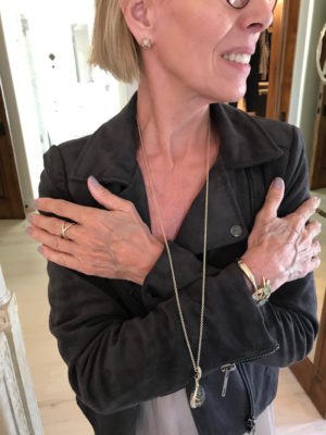 gold and crystal stud earrings. gold crossover ring, gold long chain necklace, gold large stone necklace, gold multi-color stone bracelet