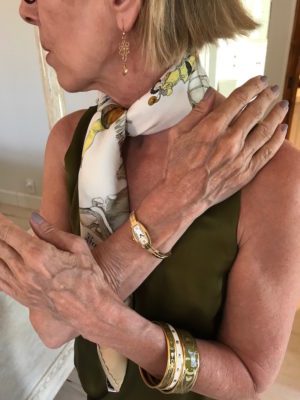 gold drop earrings, gold watch, gold and green bracelets, gold and green bangles