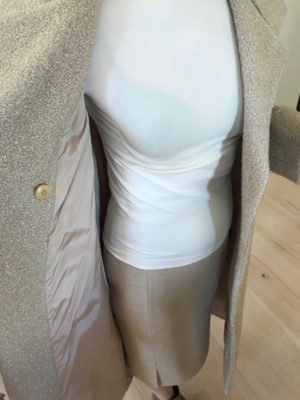 wolford white turtleneck top, beige skirt, beige mid-length skirt