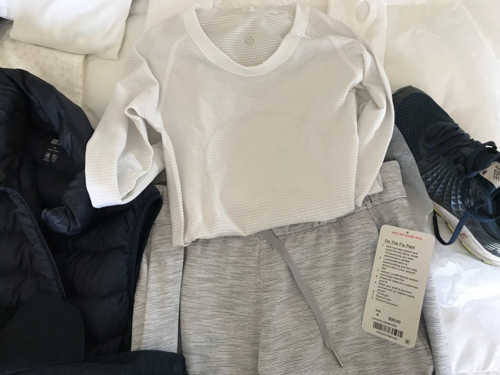 lululemon white long sleeve top, uniqlo grey joggers, uniqlo navy blue zip up vest, new balance navy blue sneakers