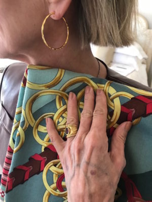 gold hoop earrings, gold and purple stone ring, green multi-color print scarf