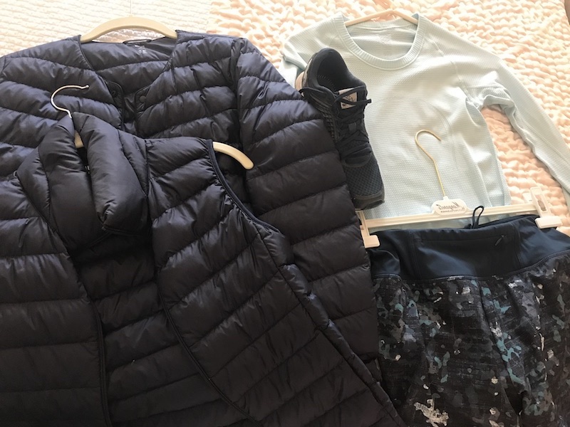 sea foam green waffle knit long sleeve shirt, Sweaty Betty multi color jogging pants, black puffer vest, black puffer jacket, New Balance black sneakers