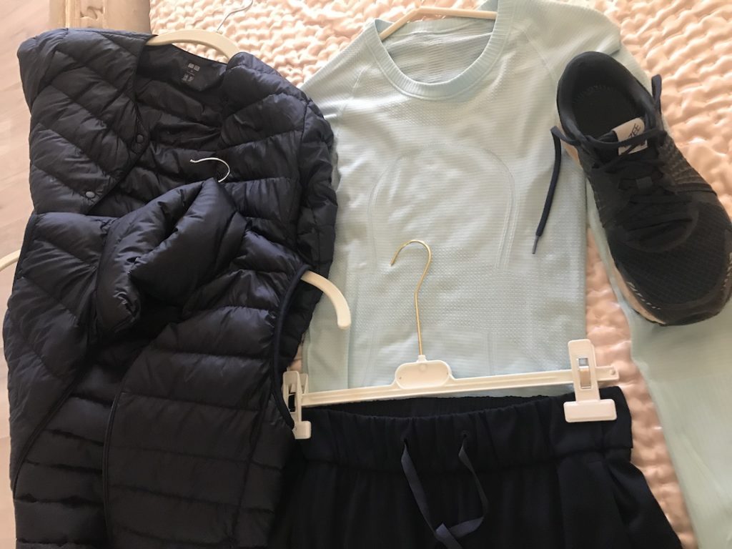 sea foam green long sleeve shirt, New Balance black sneakers, black drawstring pants, black puffer jacket, black puffer vest