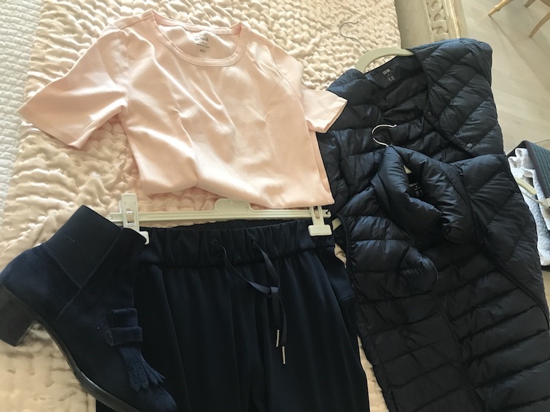 light pink short sleeve t shirt, black athletic pants, black puffer jacket, black puffer vest, Gravati boots
